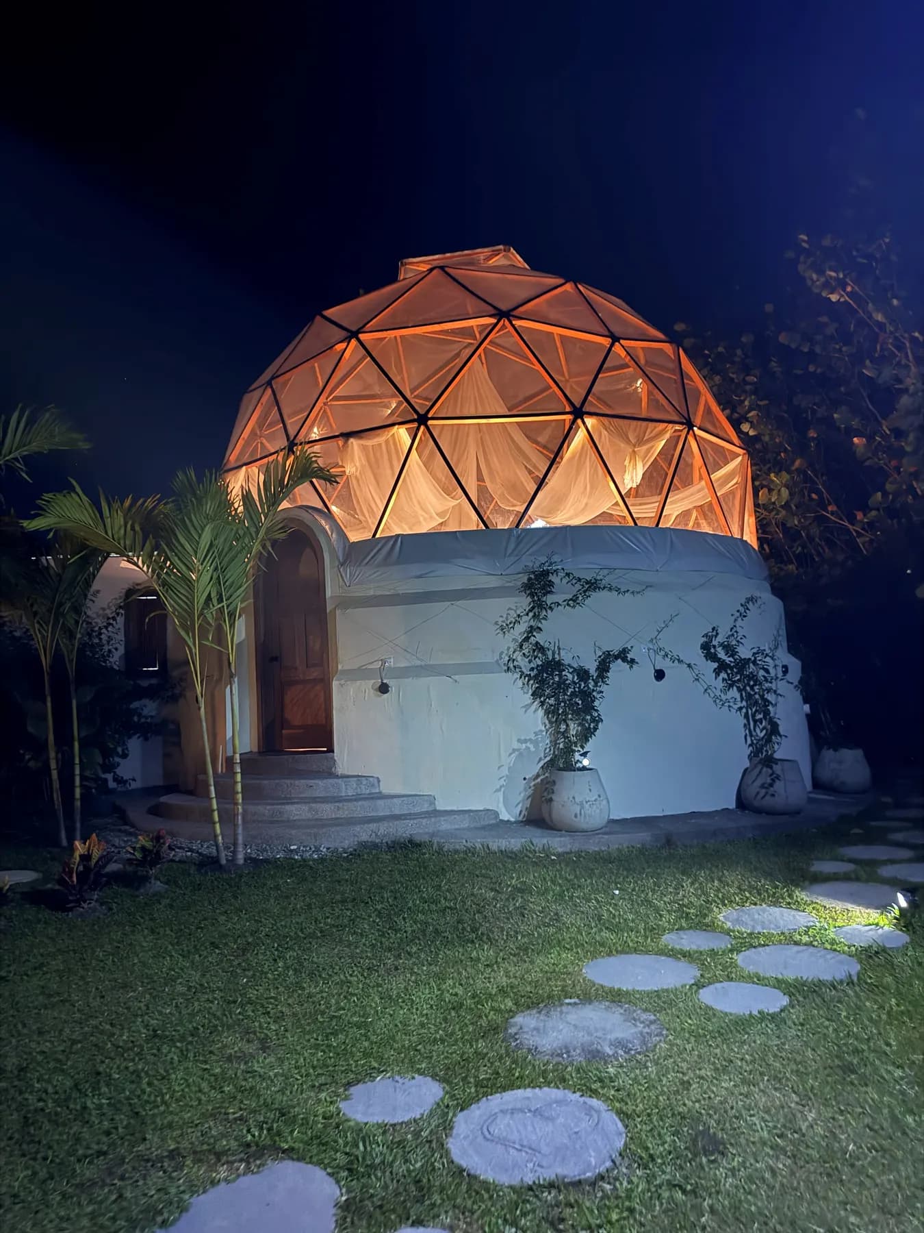 The dome lit at night, the stepping-stone path in the foreground