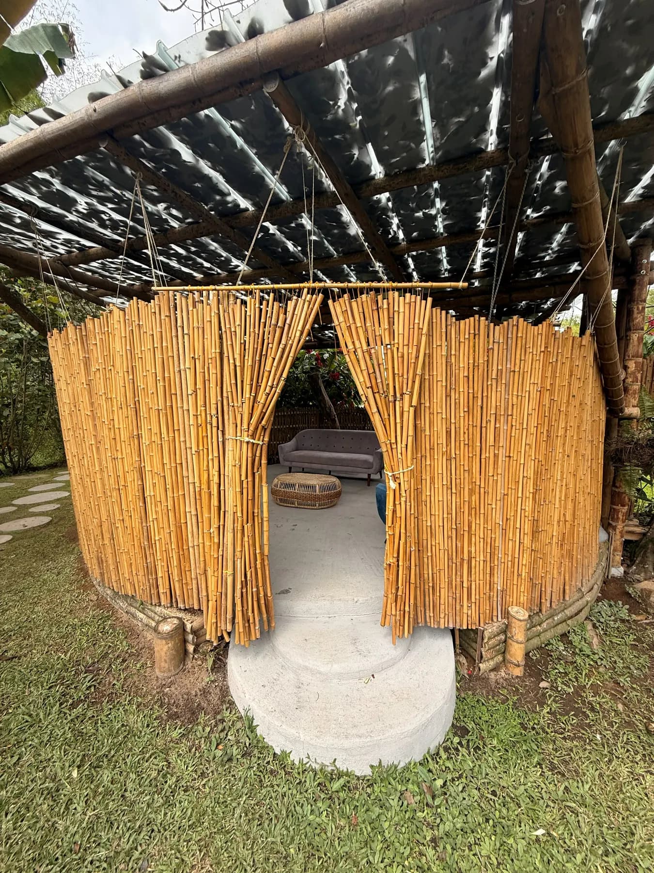 Bamboo nook with a hammock and sofas under a pergola