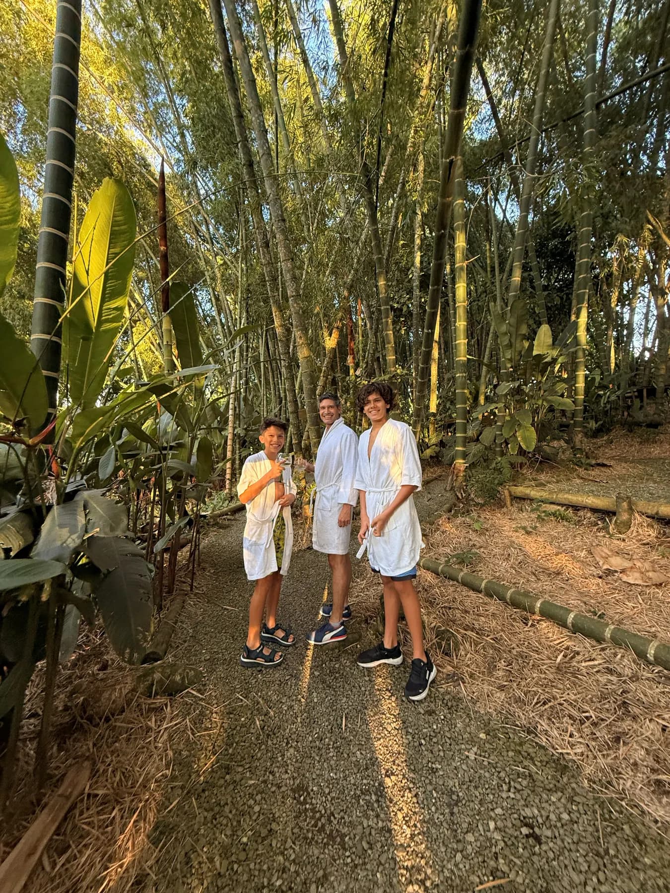 Robed guests walking the bamboo trail towards the spa