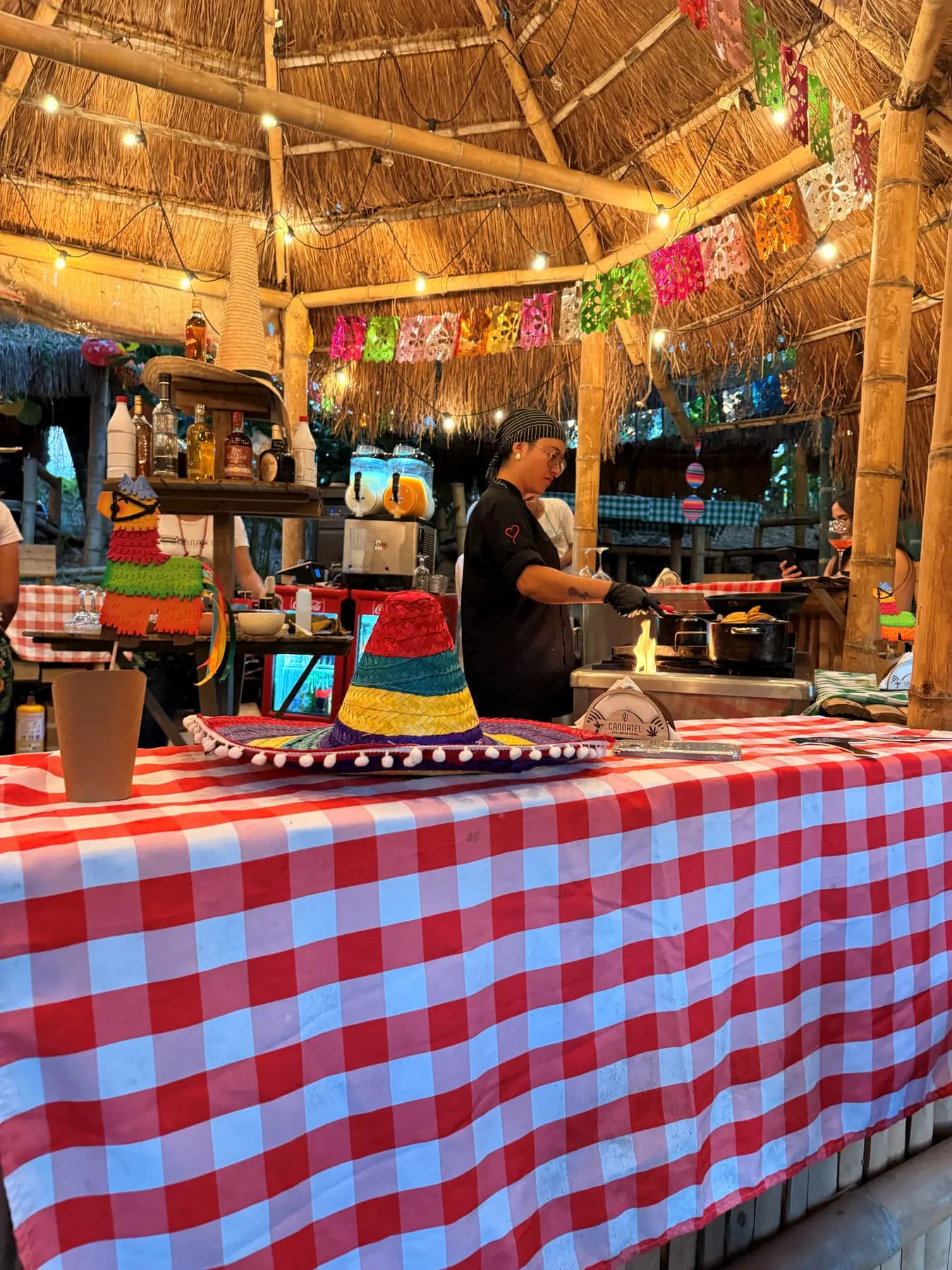 The taquería counter with a checked cloth and colourful bunting