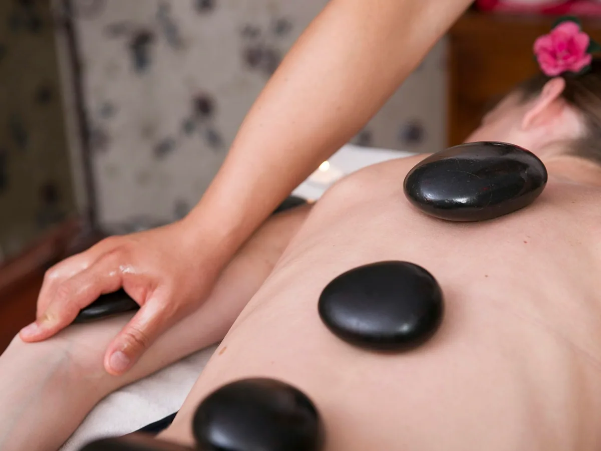 Hot stones on a woman’s back during a massage