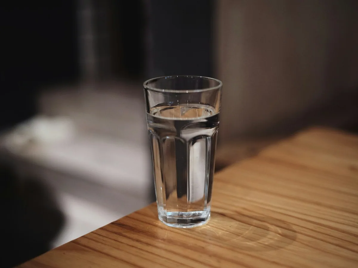A glass of water on a wooden table