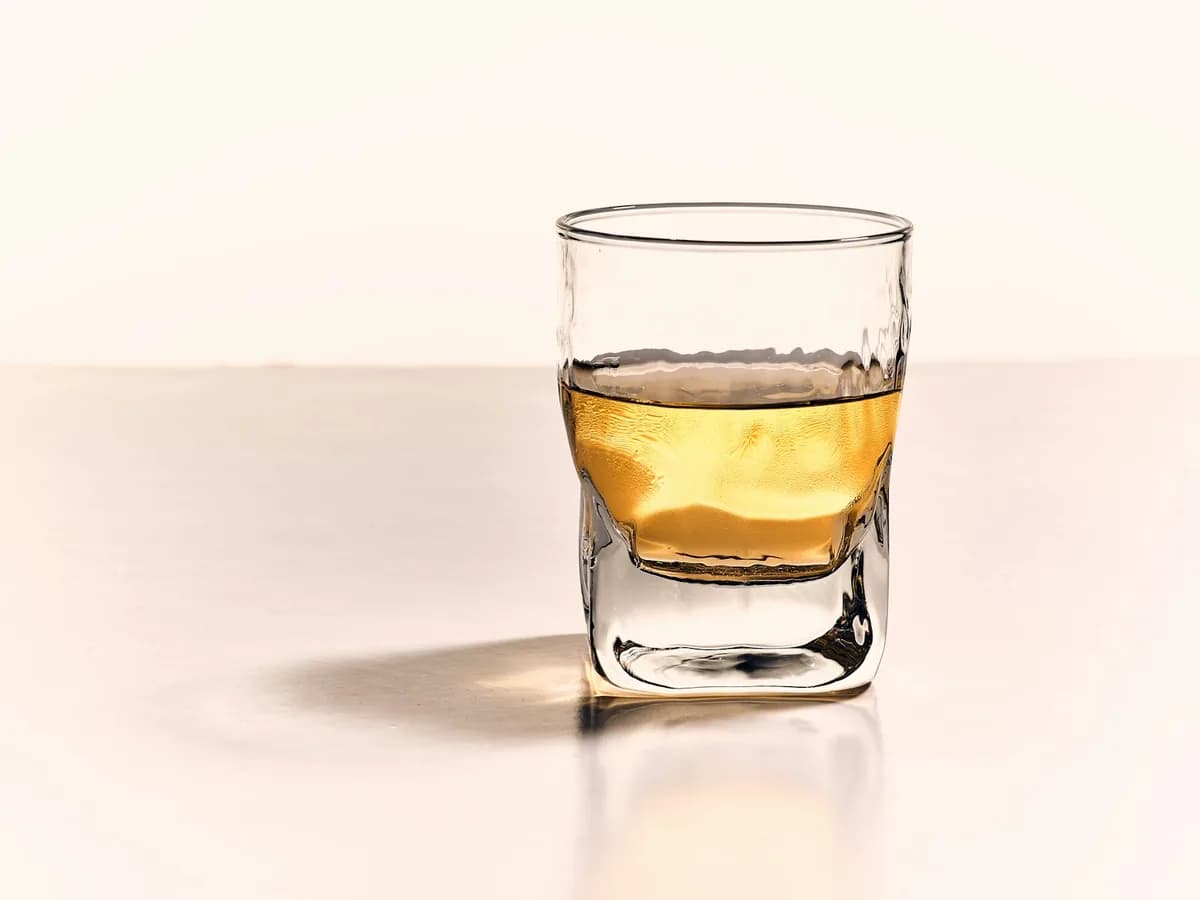 A shot of aguardiente against a white ground