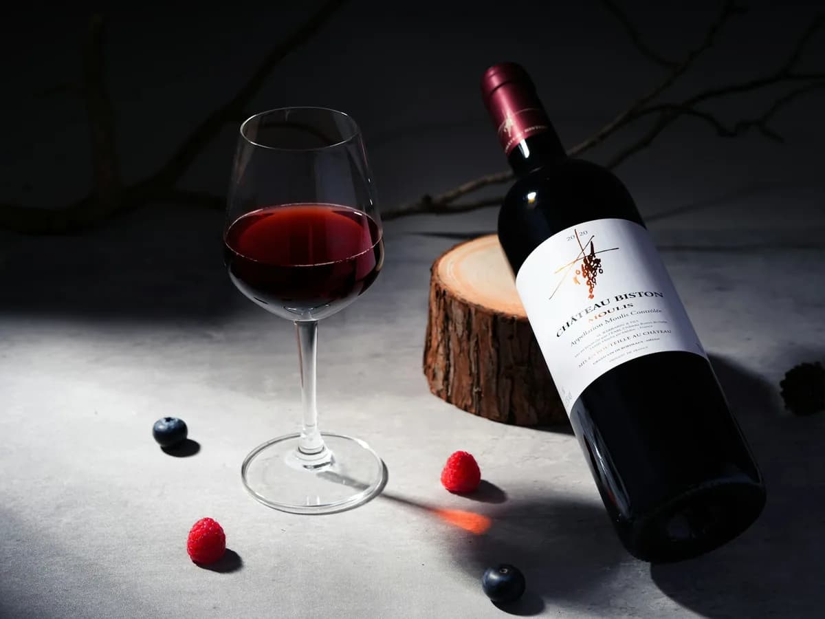 A bottle and glass of red wine
