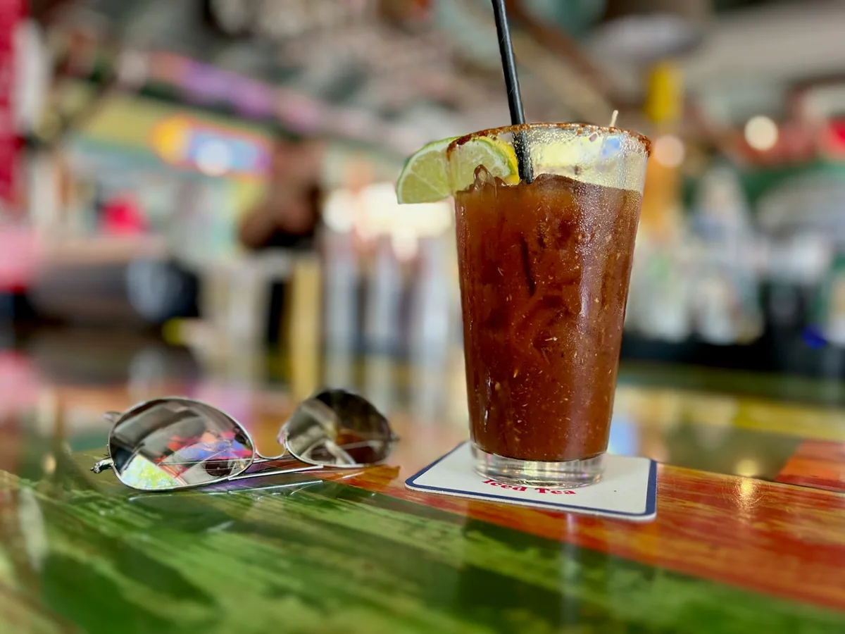 A bloody mary with celery at a bar counter