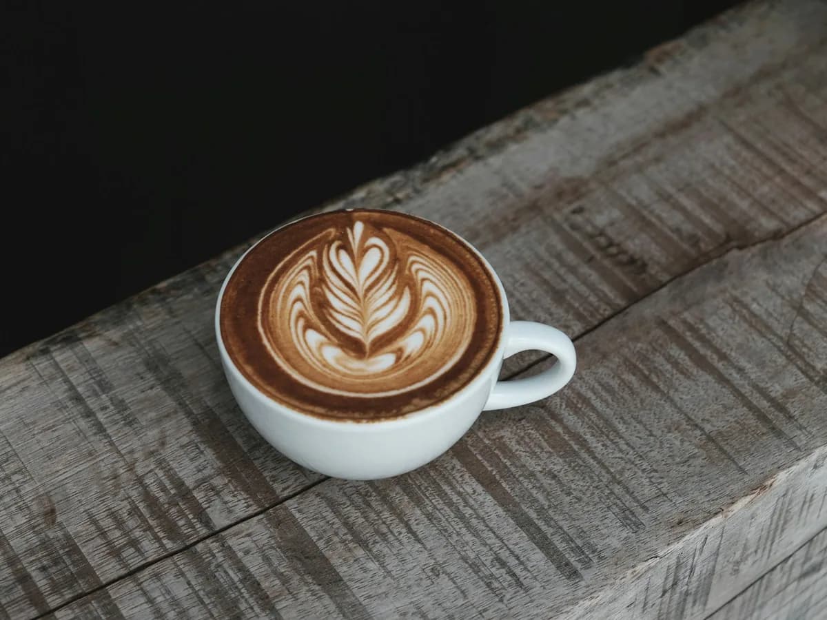 A cappuccino in a cup on wood