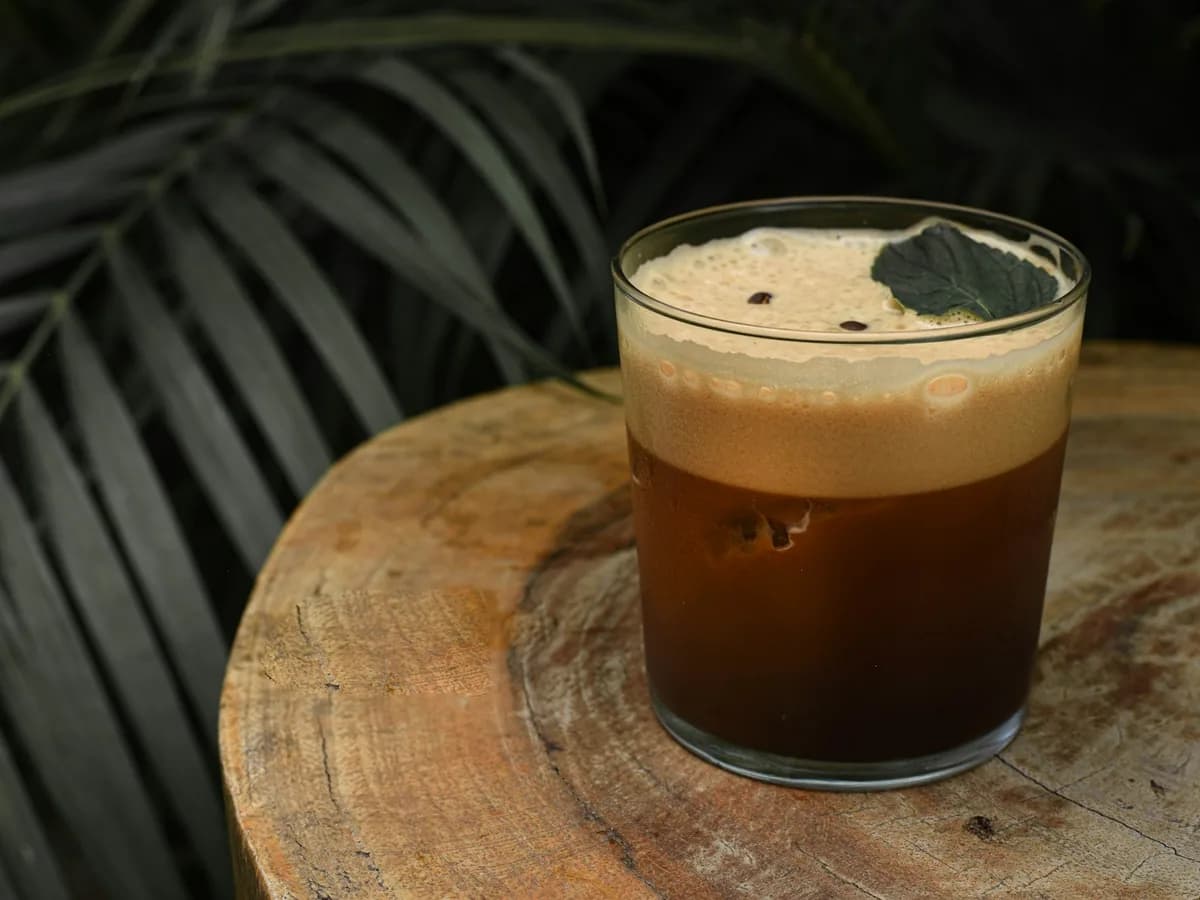 A carajillo with foam in a short glass