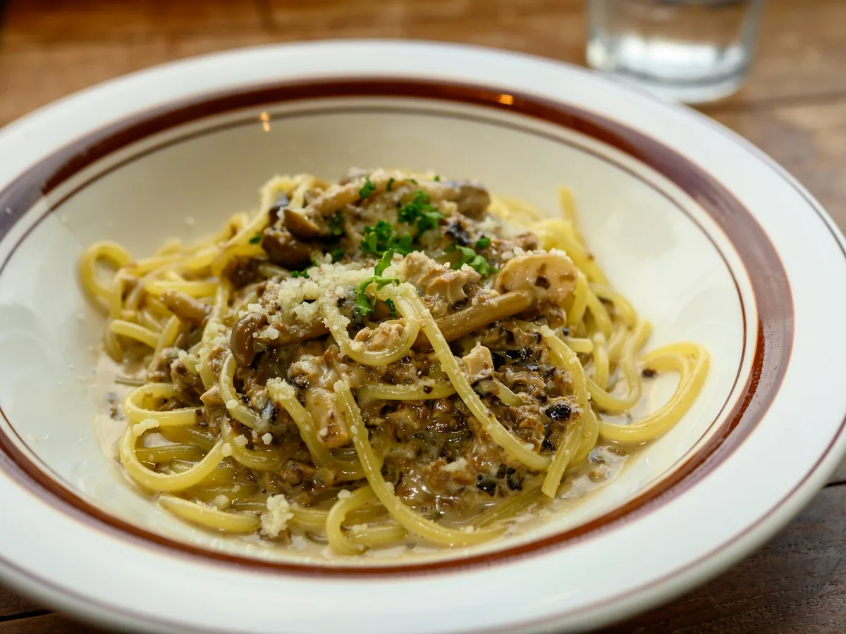 A plate of spaghetti carbonara with pancetta and cheese