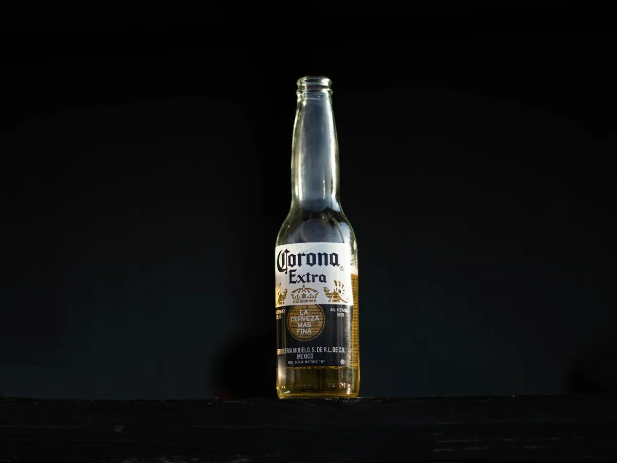 A bottle of Corona beer against a dark ground