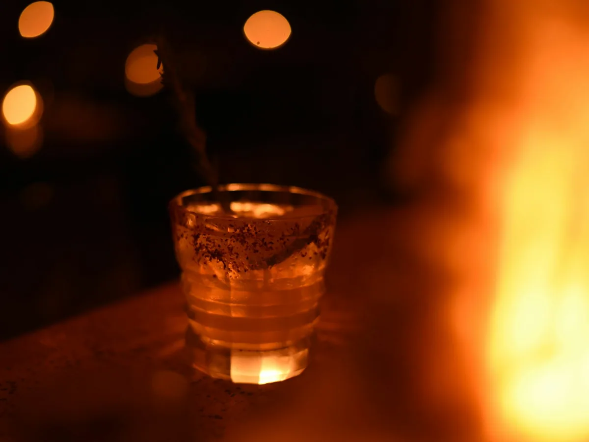 A glass of mezcal by candlelight