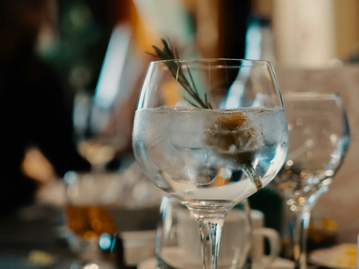 A gin and tonic in a balloon glass on a table