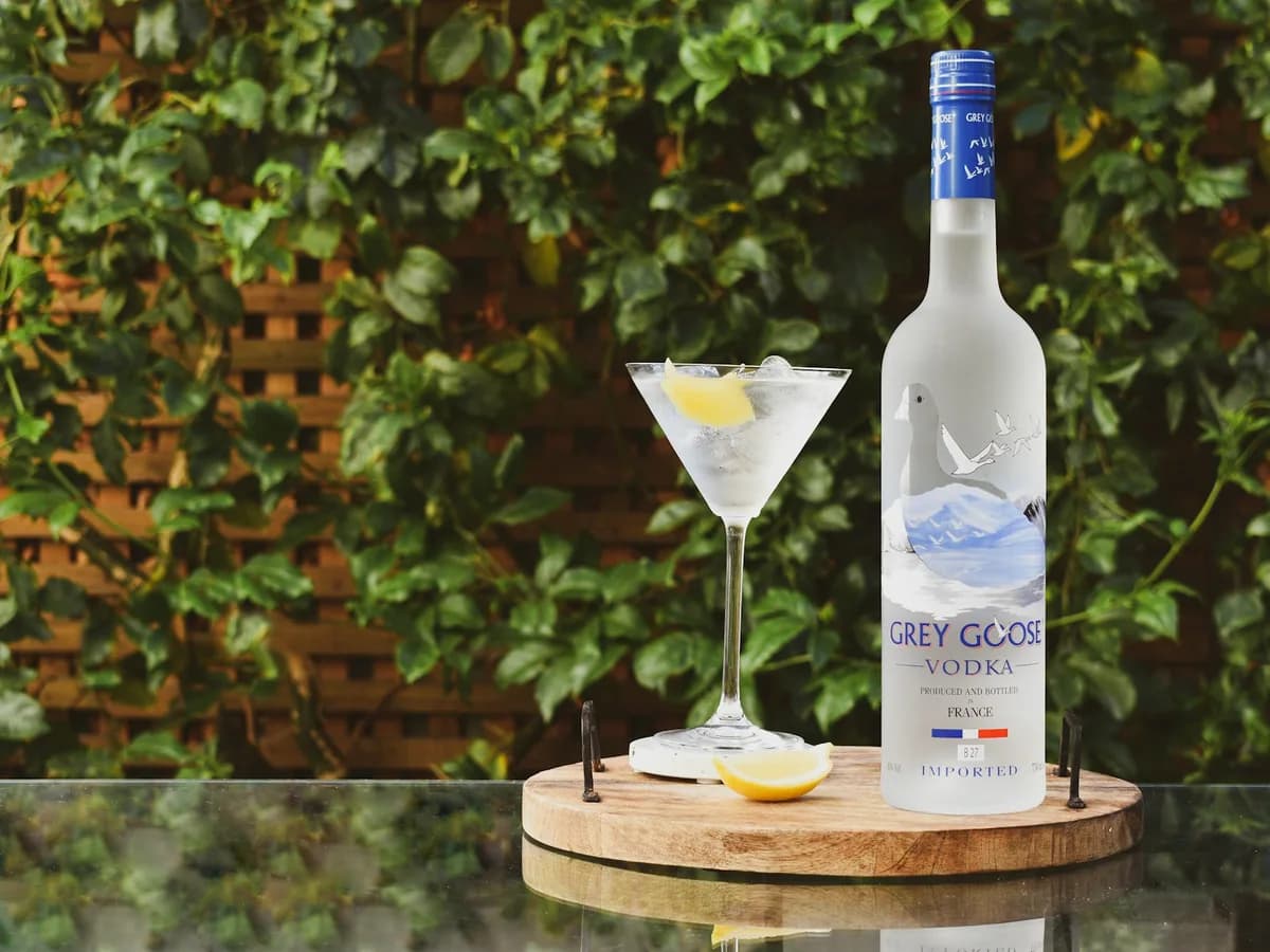 A bottle of Grey Goose beside a martini