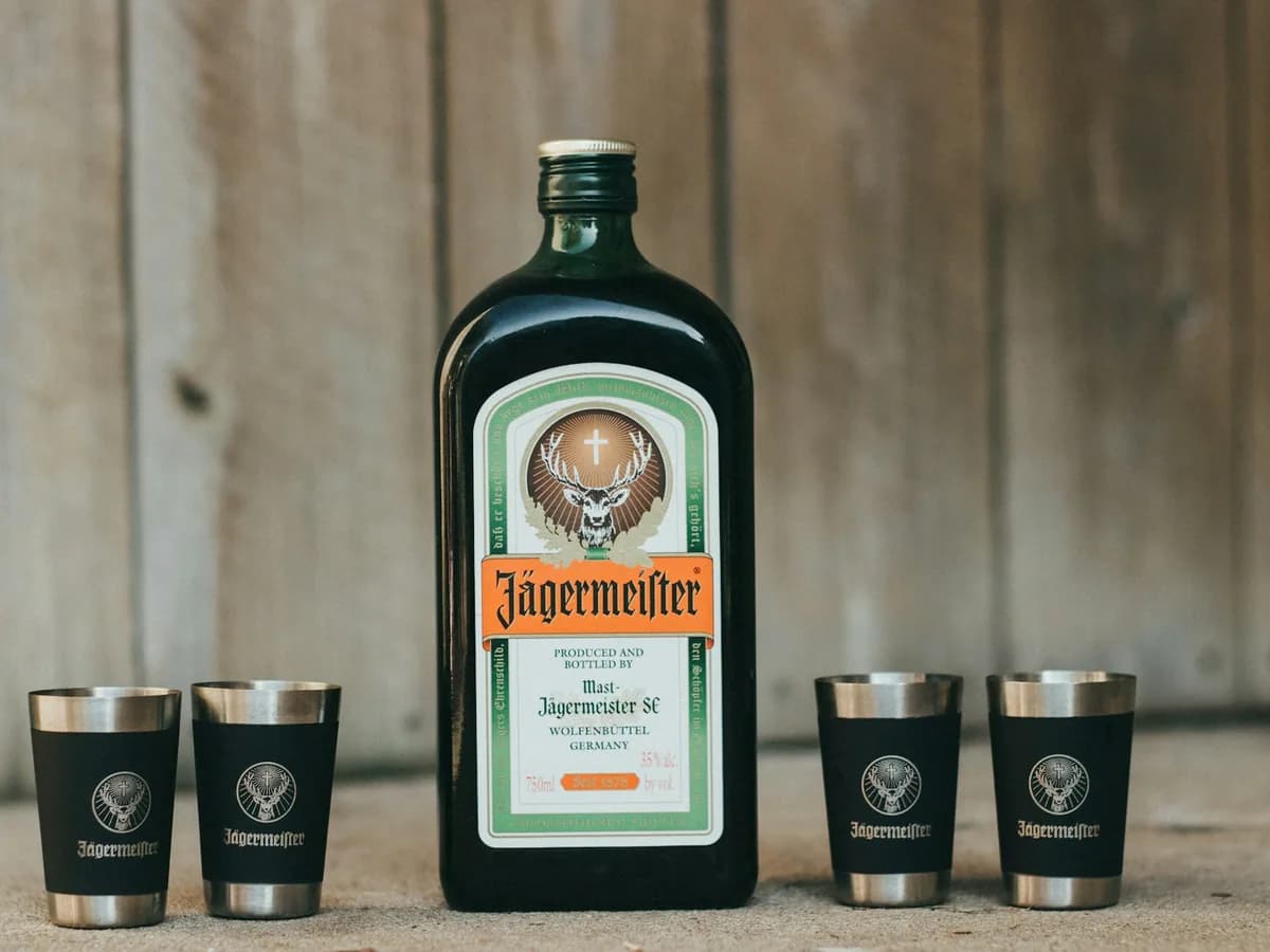 A bottle of Jägermeister with two cups