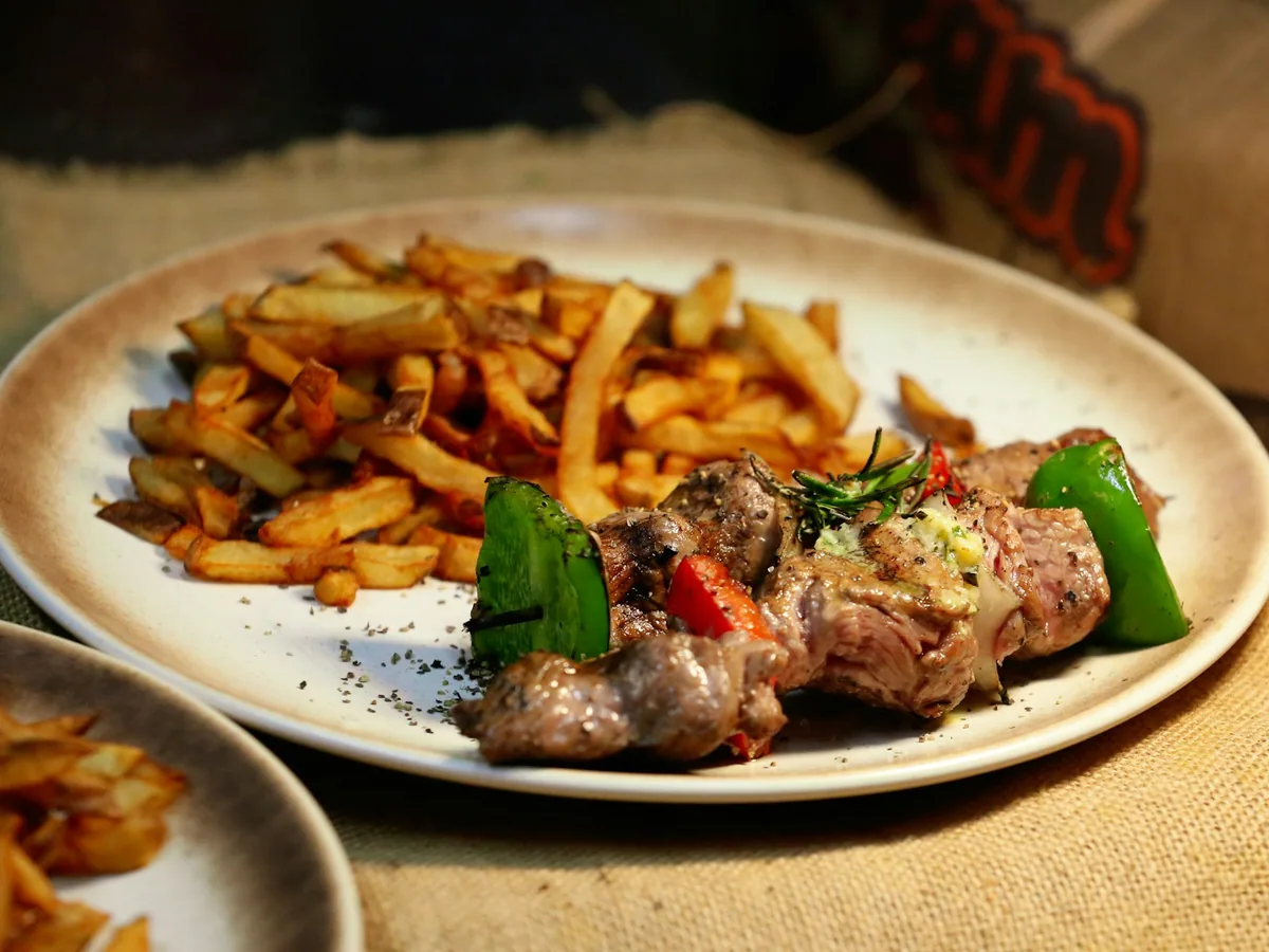 Lomo saltado with fried potatoes and peppers on a plate
