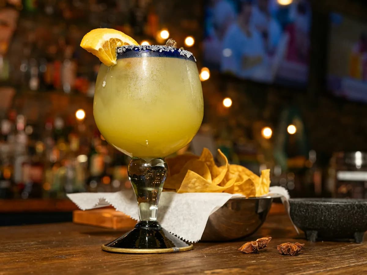 A margarita with a salt rim and a slice of lime