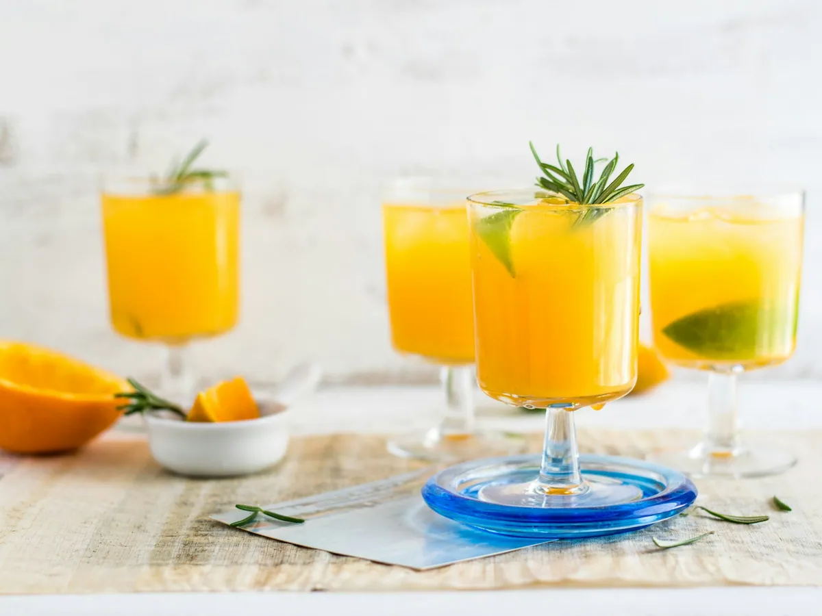 Three mimosa glasses with orange