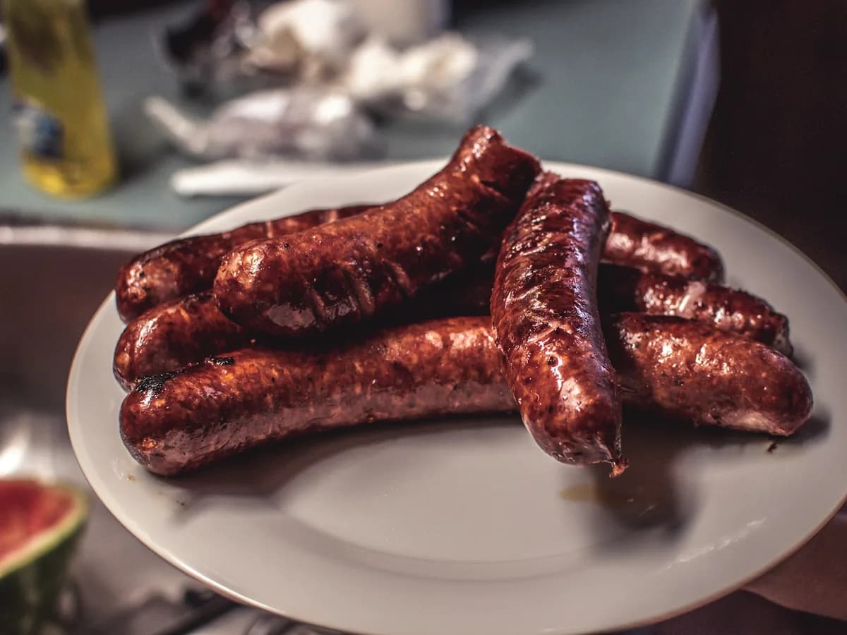 Grilled morcilla sausages on a white plate