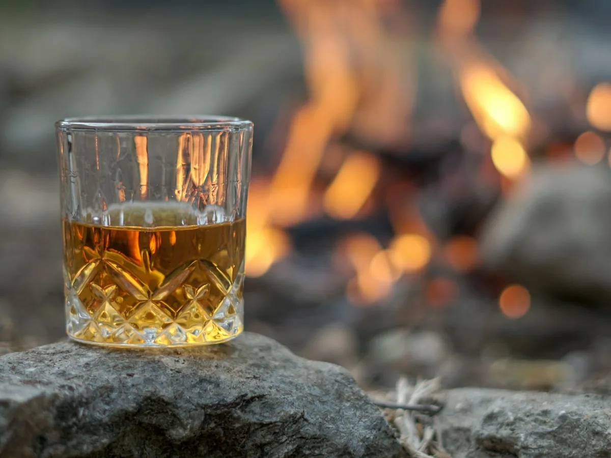 A glass of whisky by a fire