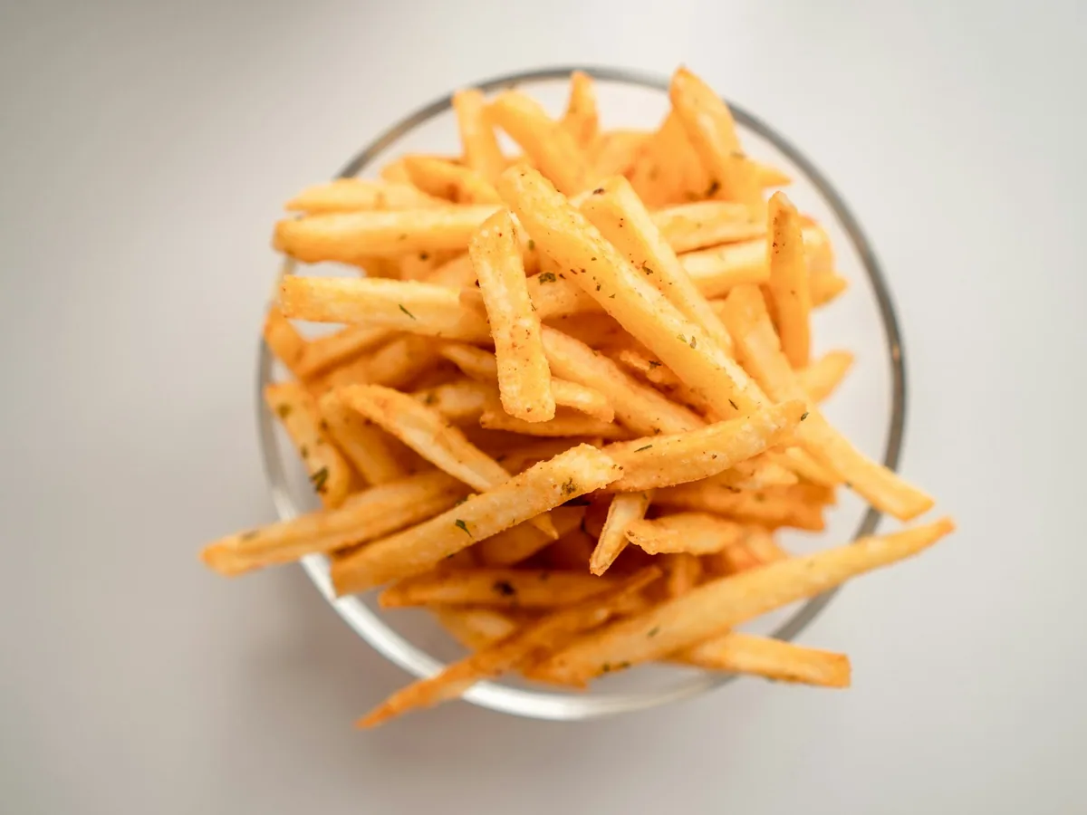French fries in a white bowl, seen from above