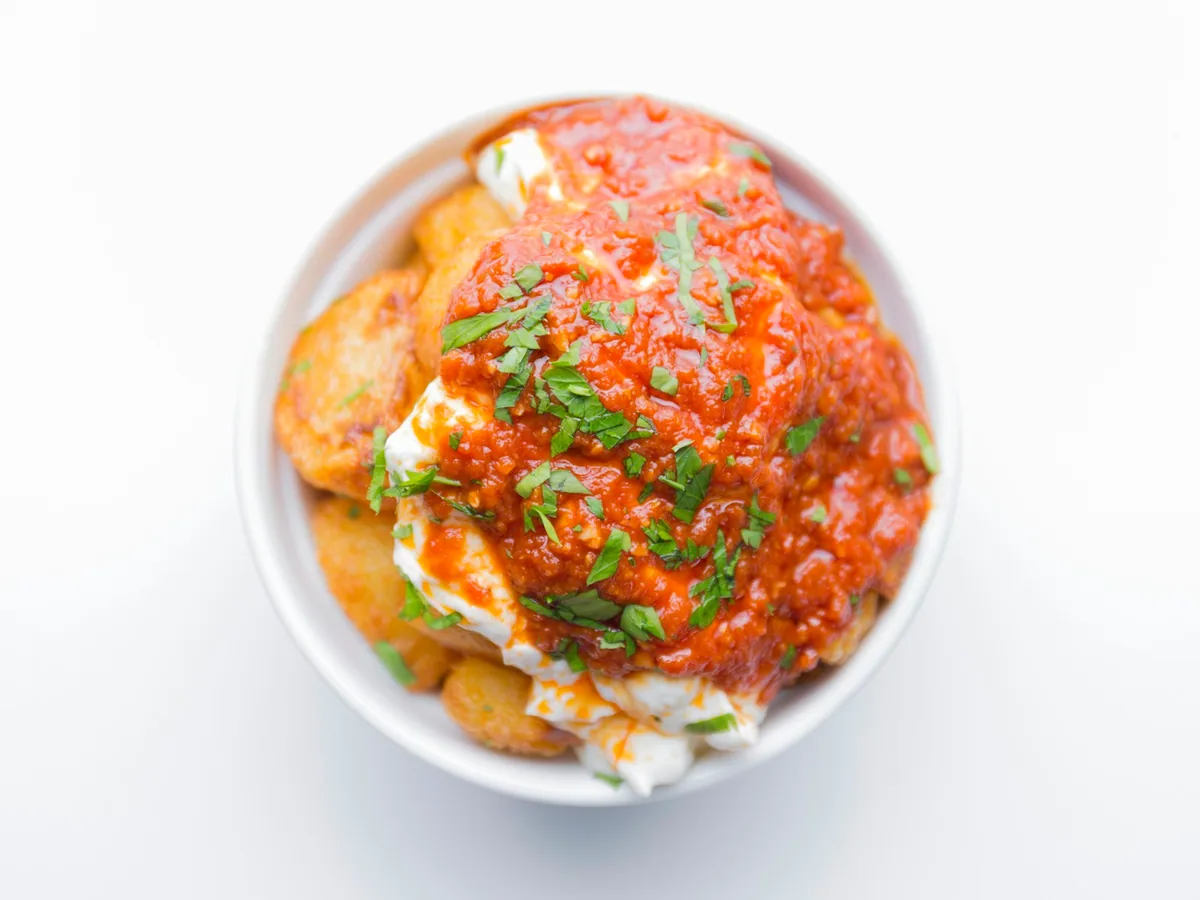 Patatas bravas with red sauce and aioli, seen from above