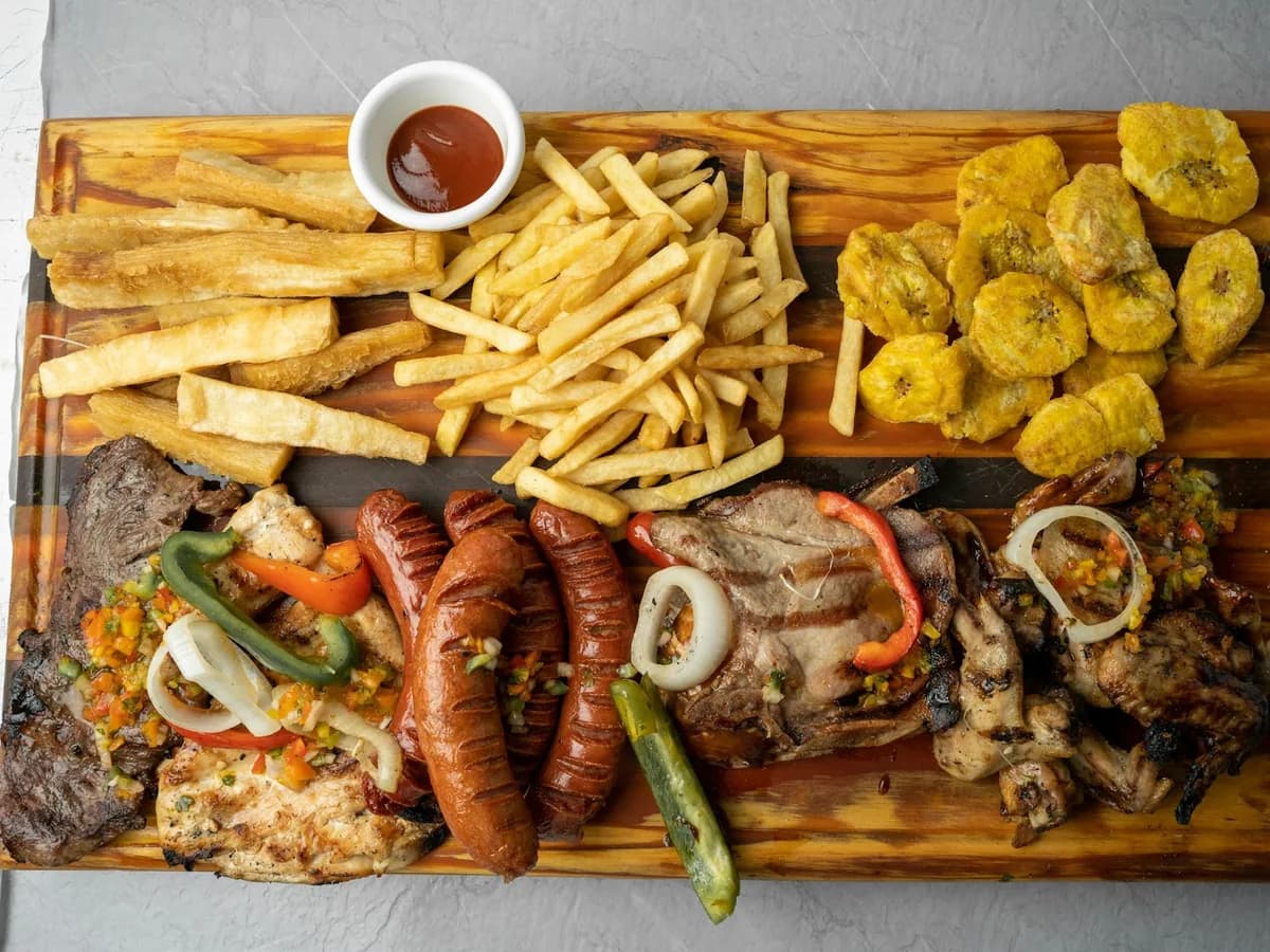 A picada served on a wooden board with sauces