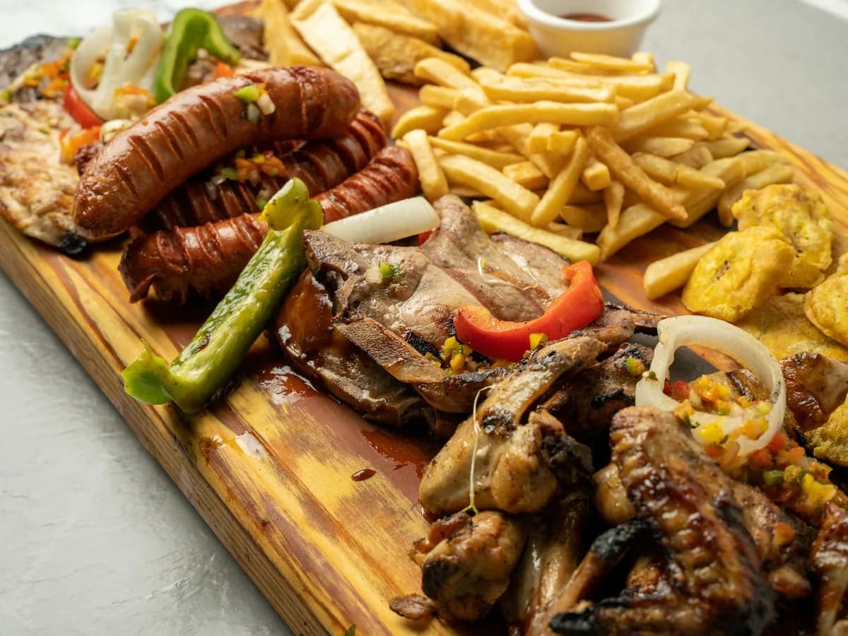 A large picada board with chorizo, meats and potatoes