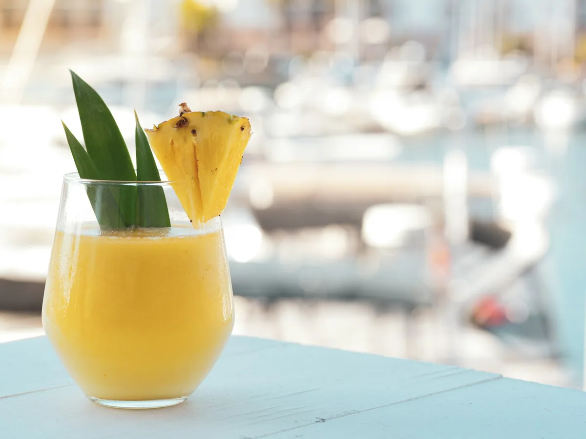 A piña colada with pineapple and a leaf