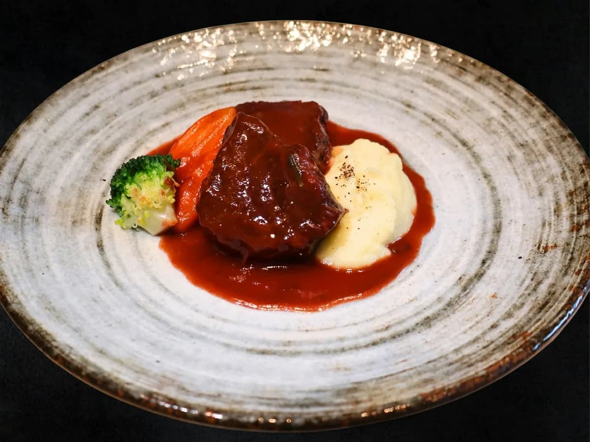 A tenderloin medallion on mashed potato with red wine sauce
