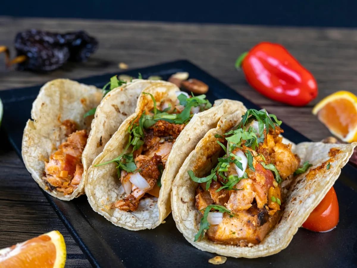 Chicken tacos with peppers on a wooden board