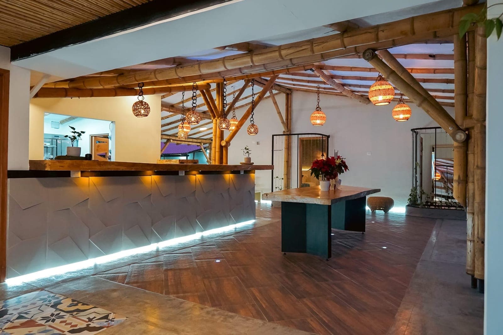 Cannatel's indoor social area, with timber structure and hanging lamps